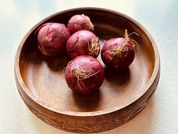 Five red onions in wooden bowl. fresh, colourful, juicy,nutritious, popular, vegetable.