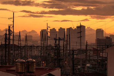 High angle view of silhouette buildings against sky during sunset