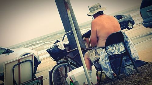 Rear view of man sitting on chair