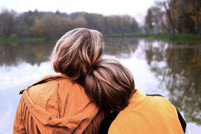 Rear view of woman against lake