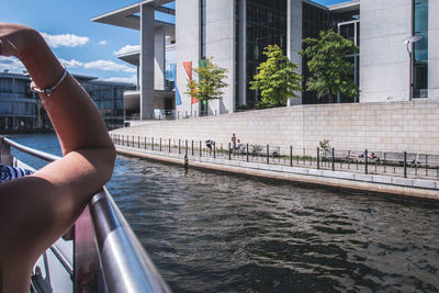 Cropped hand of woman traveling in boat on sunny day