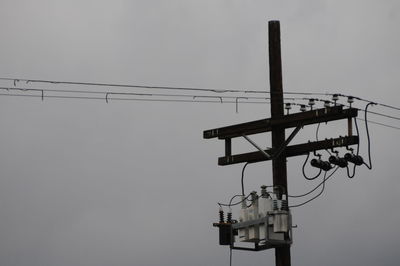 Low angle view of telephone pole against clear sky