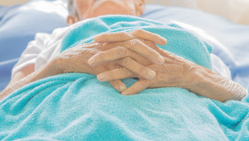 Close-up of woman lying on bed