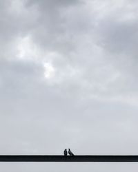 Low angle view of silhouette person against sky