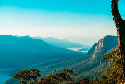 Scenic view of mountains against blue sky