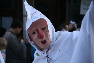 Close-up of person wearing mask and costume during event