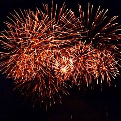 Low angle view of firework display at night