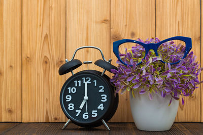 Close-up of clock on table at home