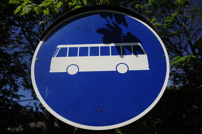 Bus stop traffic sign in europe, round blue and white sign with pictogram of a bus