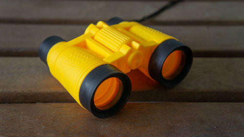 Close-up of yellow telephone on table