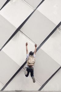 Rear view of man on white wall