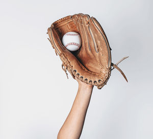 Baseball is caught in a worn baseball glove.
