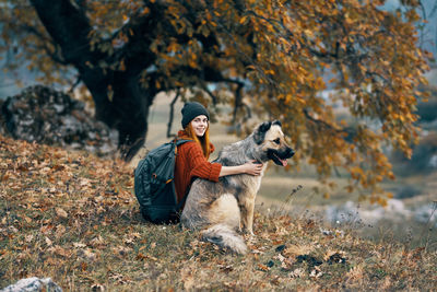 Man with dog in background