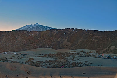 Scenic view of mountains against clear blue sky