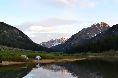 Scenic view of lake and mountains against sky