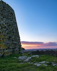 Scenic view of field against clear sky during sunset