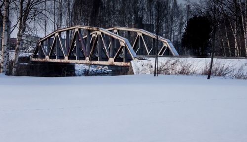 Bridge against bare trees during winter