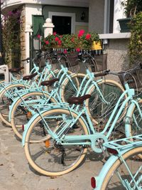 Bicycle parked by railing of building