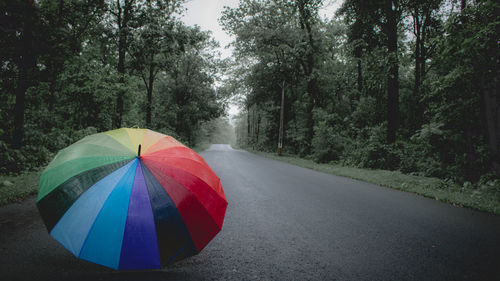 Multi colored umbrella on road