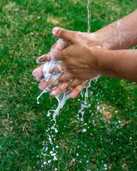 Cropped image of man washing hands