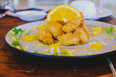 Close-up of lemon slice in plate on table