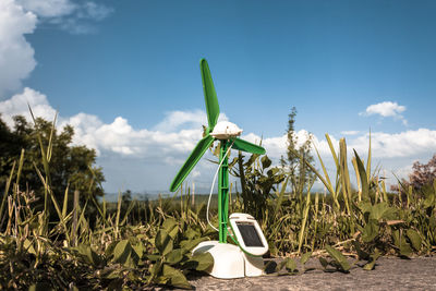 Traditional windmill on field against sky