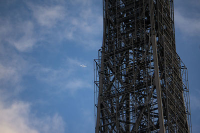 Low angle view of crane against sky