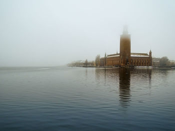 Scenic view of lake against cloudy sky