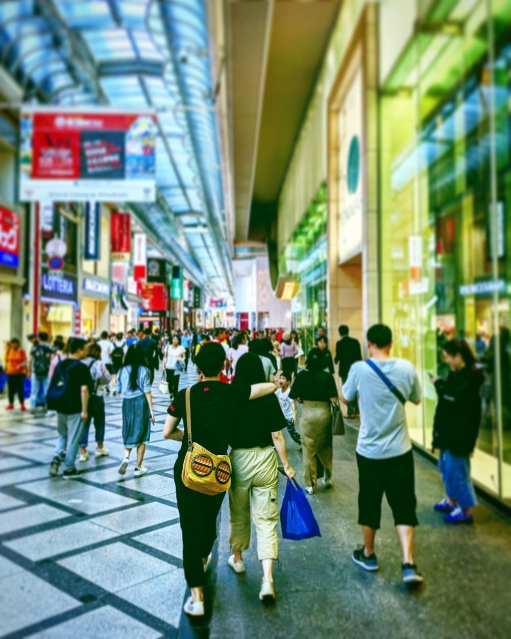 GROUP OF PEOPLE WALKING ON STREET IN CITY