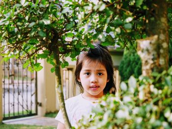 Portrait of girl seen through plants