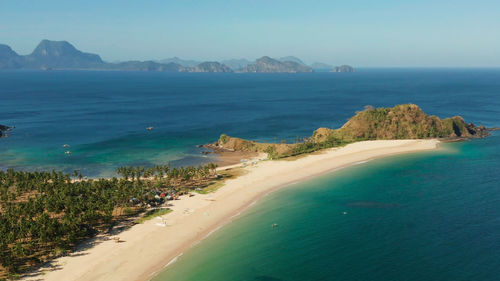 Blue sea and tropical beach, aerial drone. nacpan, el nido, palawan, philippine islands. 
