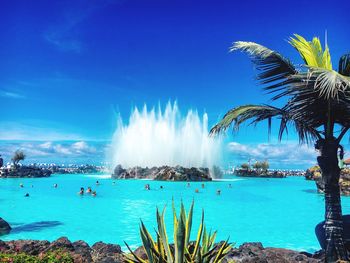 Panoramic view of swimming pool against blue sky