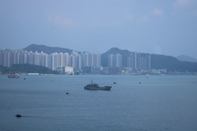 Scenic view of sea and city against sky