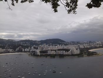 River amidst buildings in city against sky