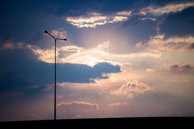 Low angle view of street light against sky at sunset