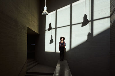 Woman sunbathing inside a building