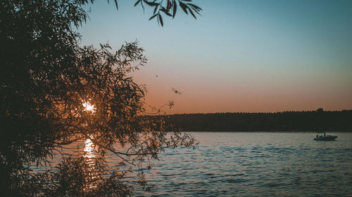 Scenic view of lake against sky at sunset