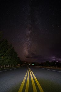 Scenic view of road against sky at night