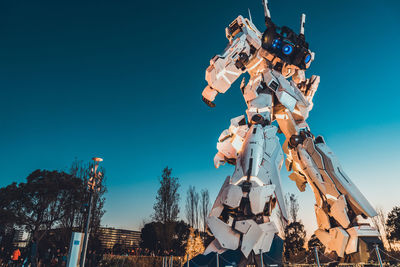 Low angle view of sculpture against clear blue sky