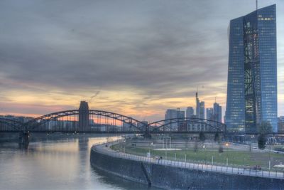 Bridge over river with city in background