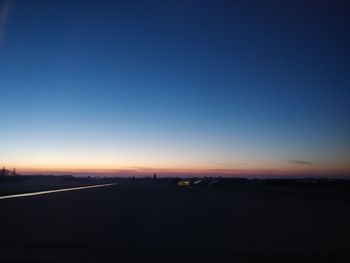 Silhouette landscape against clear sky at sunset