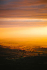 Scenic view of landscape against sky during sunset