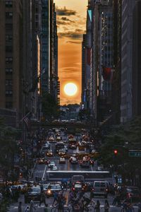 Crowded street in city during sunset