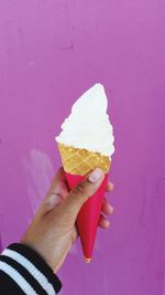 Close-up of hand holding ice cream cone