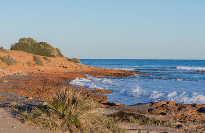 Scenic view of sea against clear blue sky