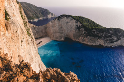 High angle view of rocks on sea shore