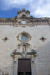 Low angle view of clock tower against sky