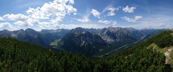 Scenic view of mountains against blue sky