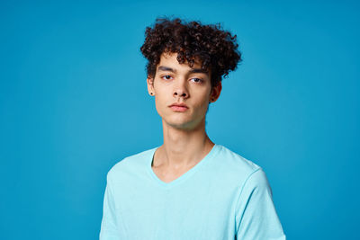 Portrait of man against blue background