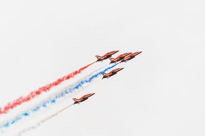 Low angle view of airshow in sky